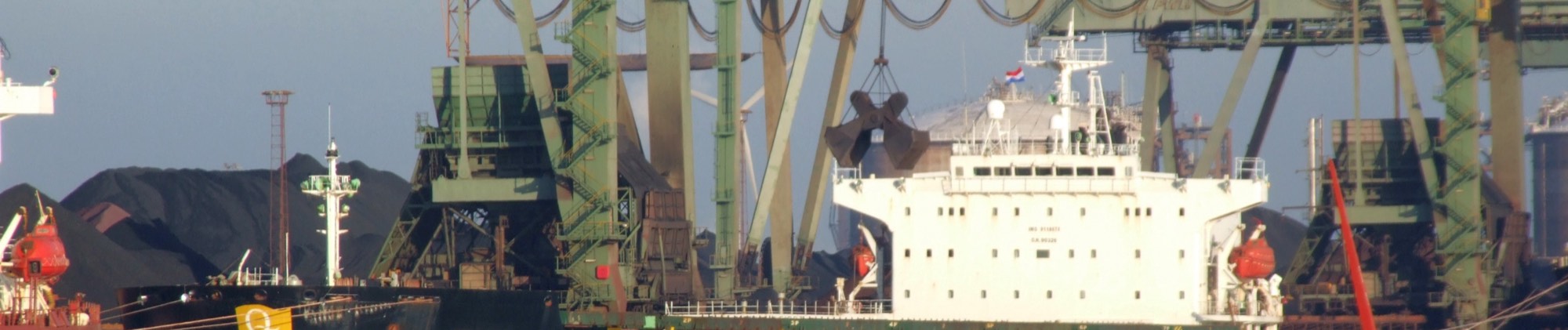Gantry unloaders discharging dry bulk cargo into stockpiles at a deep-water terminal